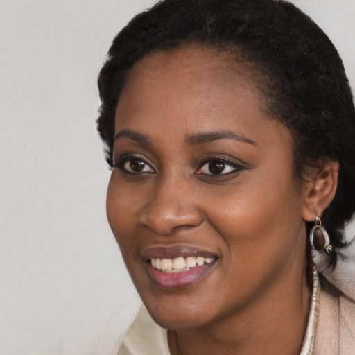 Joyful black young-adult female with short  black hair and brown eyes