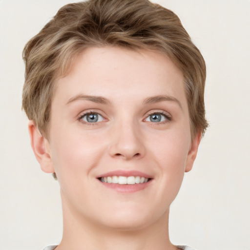 Joyful white young-adult female with short  brown hair and grey eyes