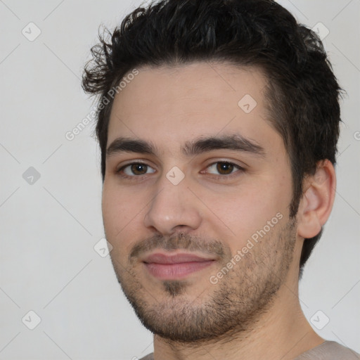 Joyful white young-adult male with short  black hair and brown eyes