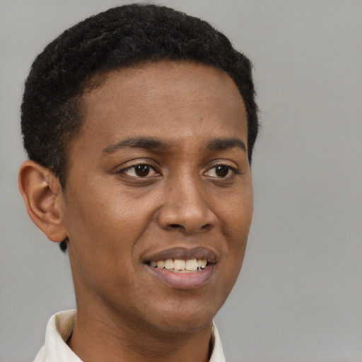Joyful black young-adult male with short  brown hair and brown eyes