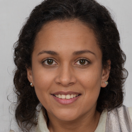 Joyful white young-adult female with long  brown hair and brown eyes