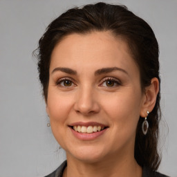 Joyful white young-adult female with medium  brown hair and brown eyes