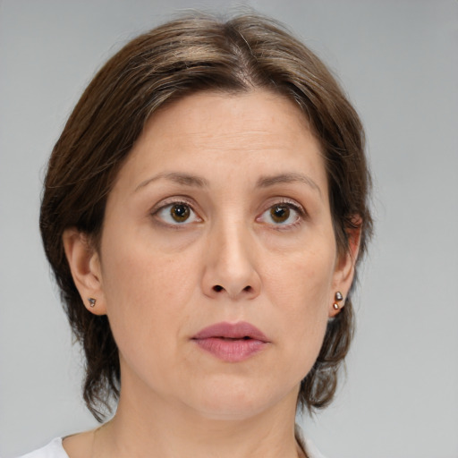 Joyful white adult female with medium  brown hair and grey eyes