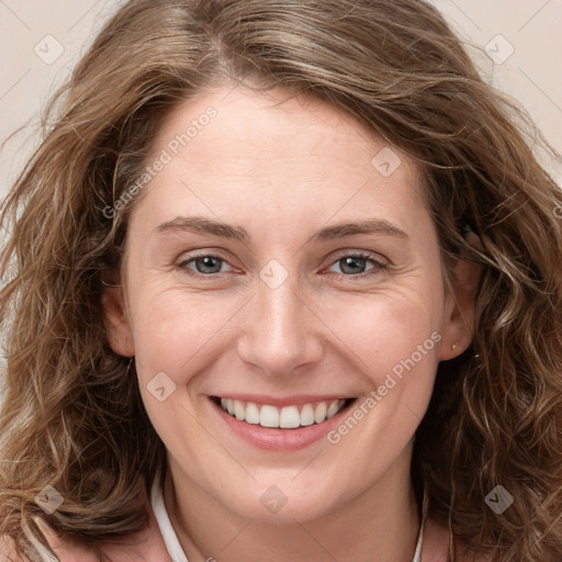 Joyful white young-adult female with long  brown hair and green eyes