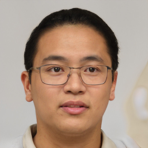 Joyful asian young-adult male with short  brown hair and brown eyes