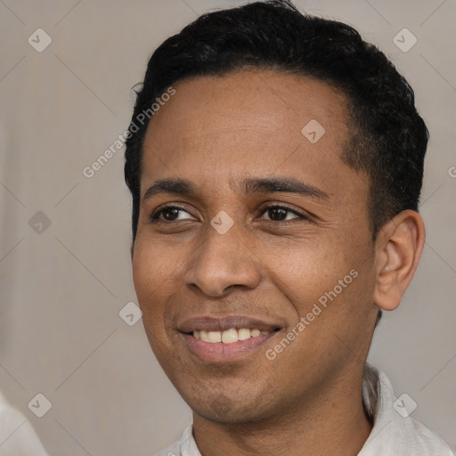 Joyful latino young-adult male with short  black hair and brown eyes