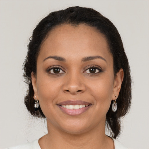 Joyful latino young-adult female with long  brown hair and brown eyes