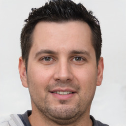 Joyful white young-adult male with short  brown hair and brown eyes