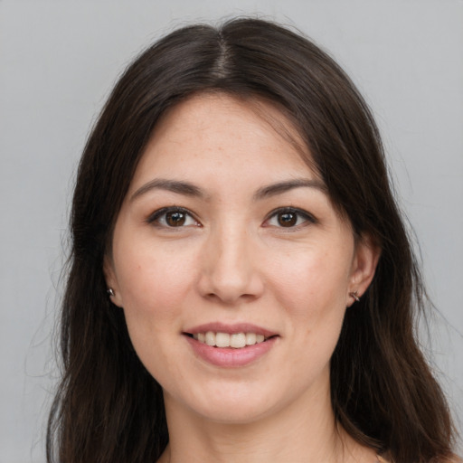 Joyful white young-adult female with long  brown hair and brown eyes
