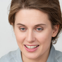 Joyful white young-adult female with medium  brown hair and blue eyes