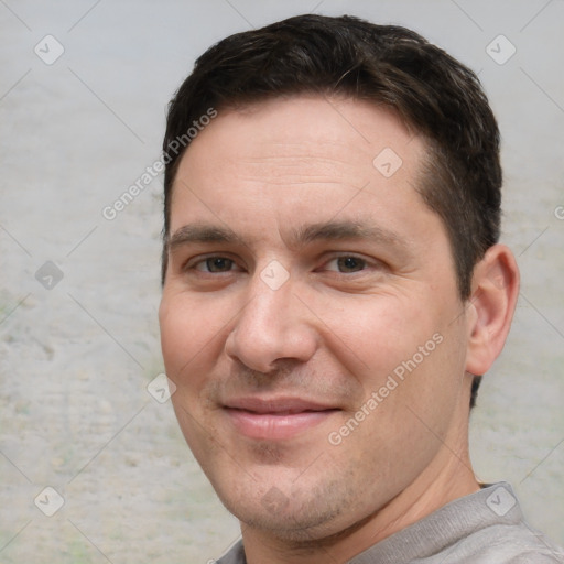 Joyful white adult male with short  brown hair and brown eyes