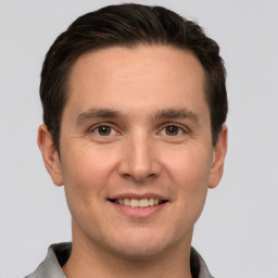 Joyful white young-adult male with short  brown hair and brown eyes