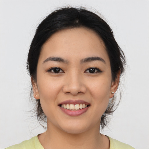 Joyful asian young-adult female with medium  black hair and brown eyes