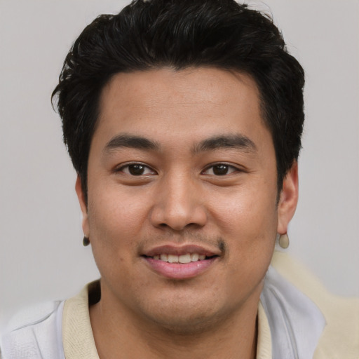 Joyful asian young-adult male with short  black hair and brown eyes