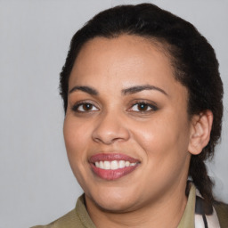 Joyful latino young-adult female with medium  black hair and brown eyes