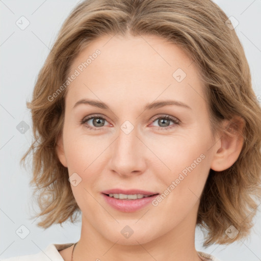 Joyful white young-adult female with medium  brown hair and blue eyes