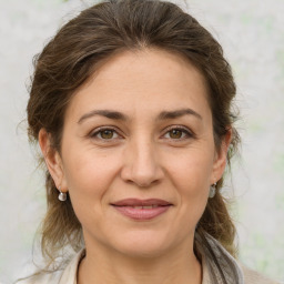 Joyful white adult female with medium  brown hair and brown eyes