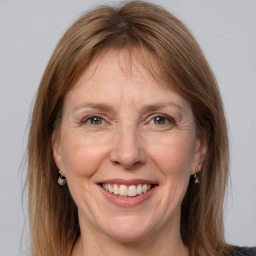 Joyful white adult female with medium  brown hair and grey eyes