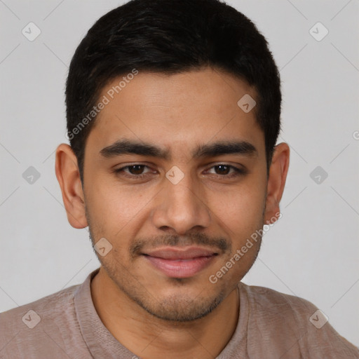 Joyful latino young-adult male with short  black hair and brown eyes