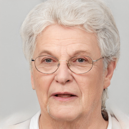 Joyful white middle-aged male with short  gray hair and blue eyes