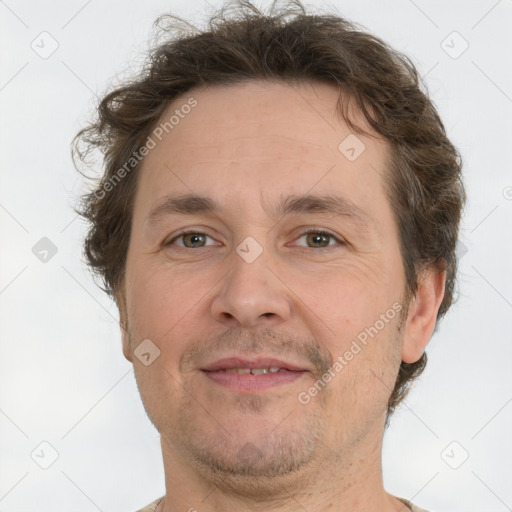 Joyful white adult male with short  brown hair and grey eyes