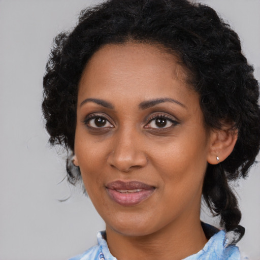 Joyful black young-adult female with medium  brown hair and brown eyes