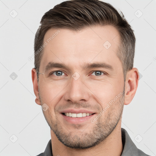 Joyful white young-adult male with short  brown hair and grey eyes