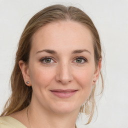 Joyful white young-adult female with medium  brown hair and blue eyes