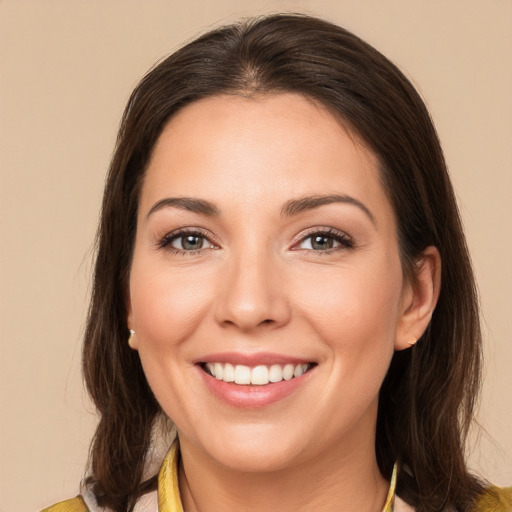 Joyful white young-adult female with medium  brown hair and brown eyes