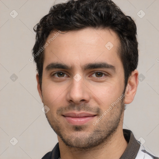 Joyful white young-adult male with short  black hair and brown eyes