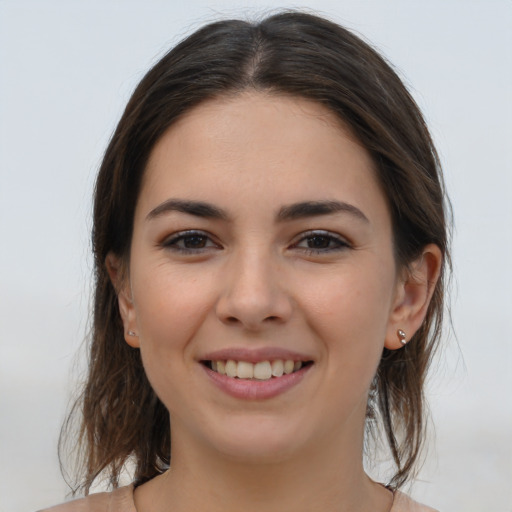 Joyful white young-adult female with medium  brown hair and brown eyes