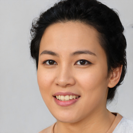 Joyful asian young-adult female with short  black hair and brown eyes