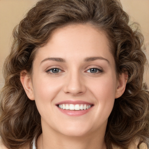 Joyful white young-adult female with long  brown hair and green eyes