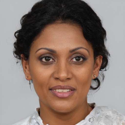 Joyful black young-adult female with medium  brown hair and brown eyes