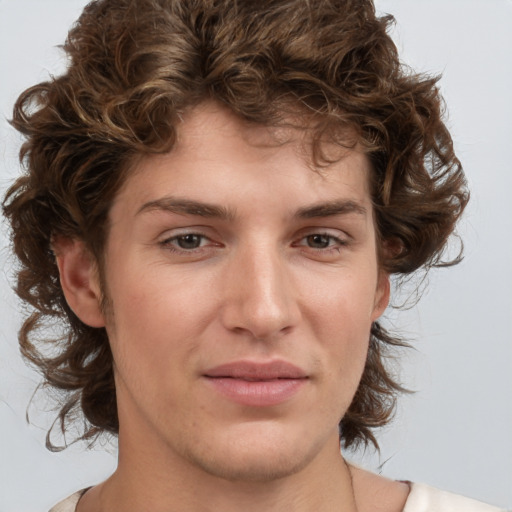 Joyful white young-adult male with medium  brown hair and brown eyes