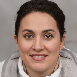 Joyful white adult female with medium  brown hair and brown eyes