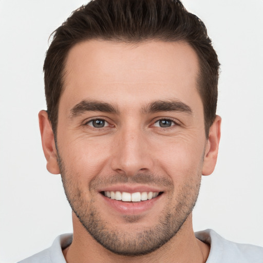 Joyful white young-adult male with short  brown hair and brown eyes