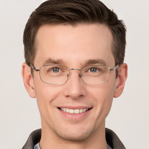 Joyful white adult male with short  brown hair and grey eyes