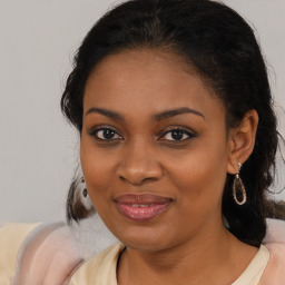 Joyful black young-adult female with medium  brown hair and brown eyes