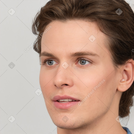 Joyful white young-adult male with medium  brown hair and grey eyes