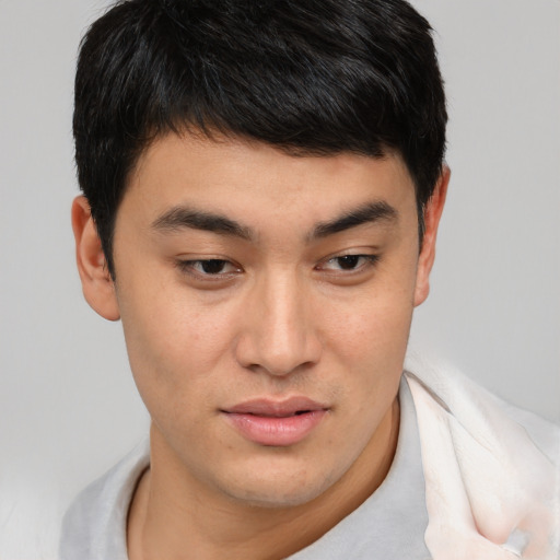 Joyful asian young-adult male with short  brown hair and brown eyes