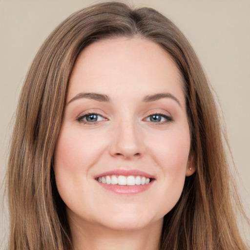 Joyful white young-adult female with long  brown hair and grey eyes