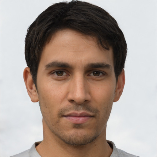 Neutral latino young-adult male with short  brown hair and brown eyes