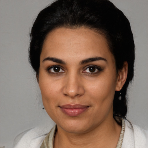 Joyful latino young-adult female with short  black hair and brown eyes