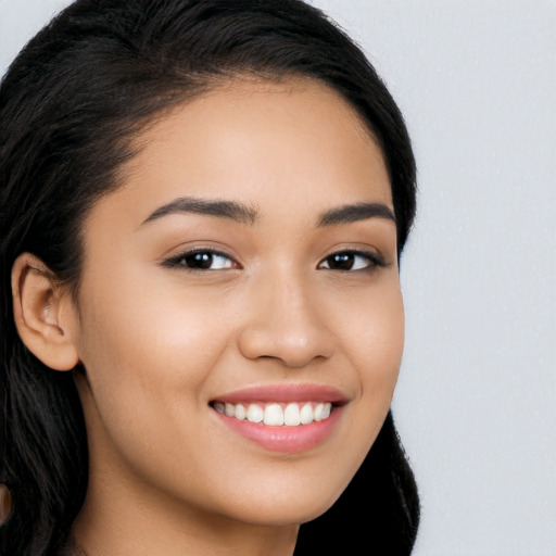 Joyful white young-adult female with long  black hair and brown eyes