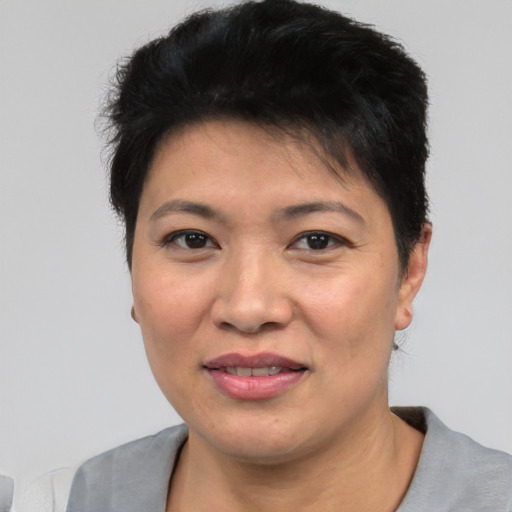 Joyful asian young-adult female with short  black hair and brown eyes