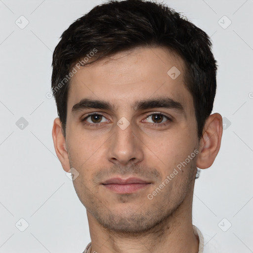 Neutral white young-adult male with short  black hair and brown eyes