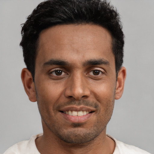 Joyful black young-adult male with short  black hair and brown eyes