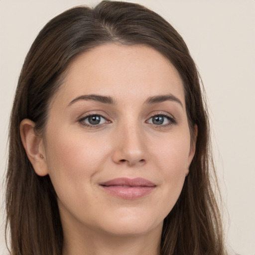 Joyful white young-adult female with long  brown hair and grey eyes