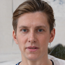 Joyful white adult male with short  brown hair and grey eyes